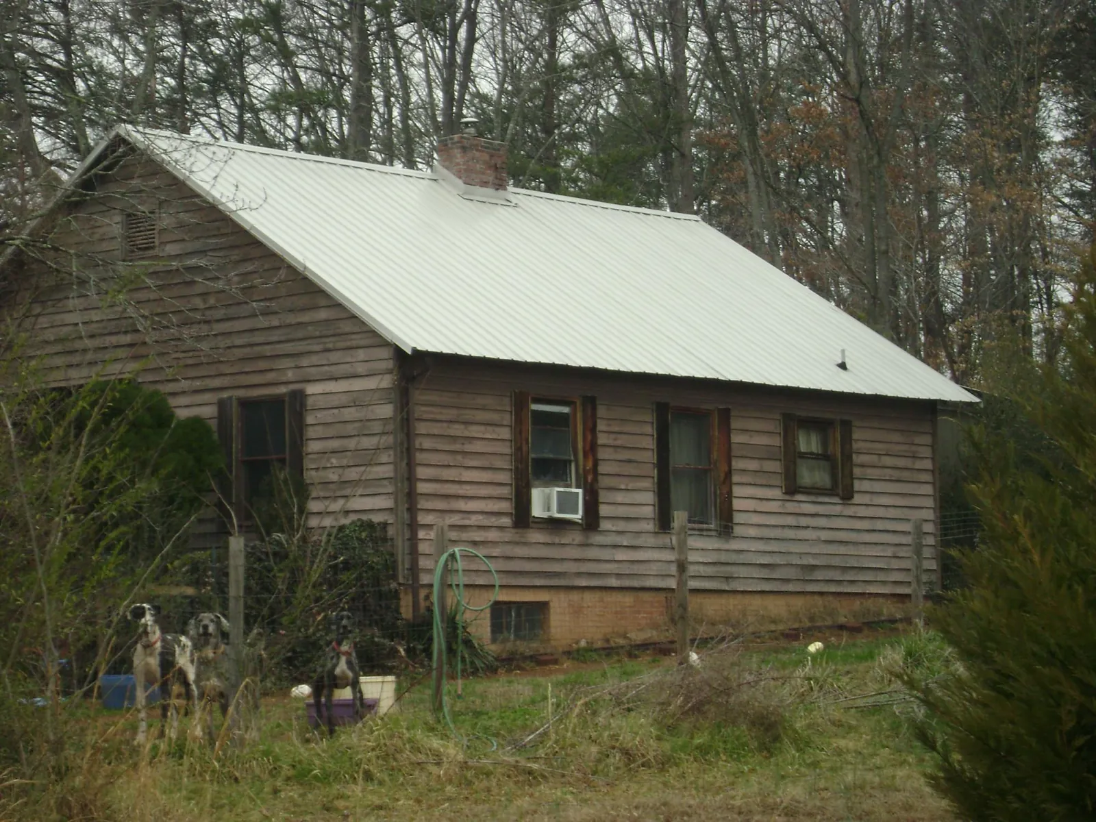 White metal roof on an old wood sided farmhouse, from a Asphalt Shingle Roof Repair job in Haworth
